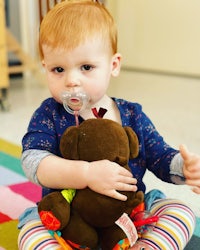 a baby holding a stuffed animal